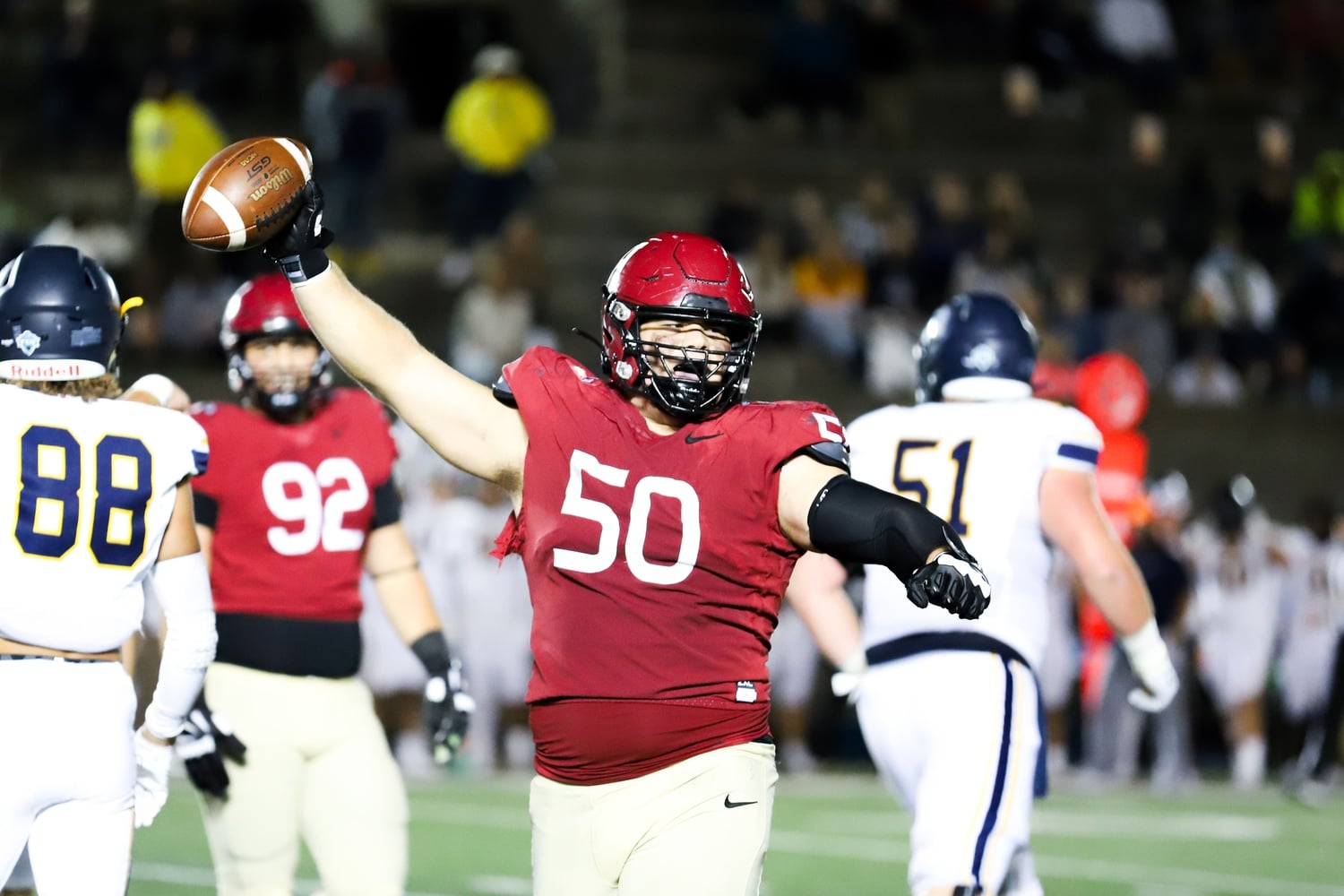 Junior defensive tackle Thor Griffith holds up the ball in celebration in a 28-21 (OT) victory over Merrimack on Sept. 16. Griffith is the fulcrum of a strong rushing defense that will be a key to beating Princeton on Friday.