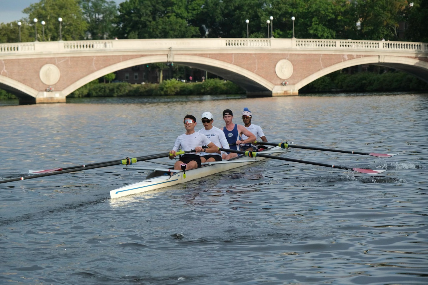Abdullah Bannan rows past the John Weeks Bridge as part of Harvard's four-man lightweight crew team. Bannan had never tried the sport before he came to Cambridge, despite watching it on television in Syria.