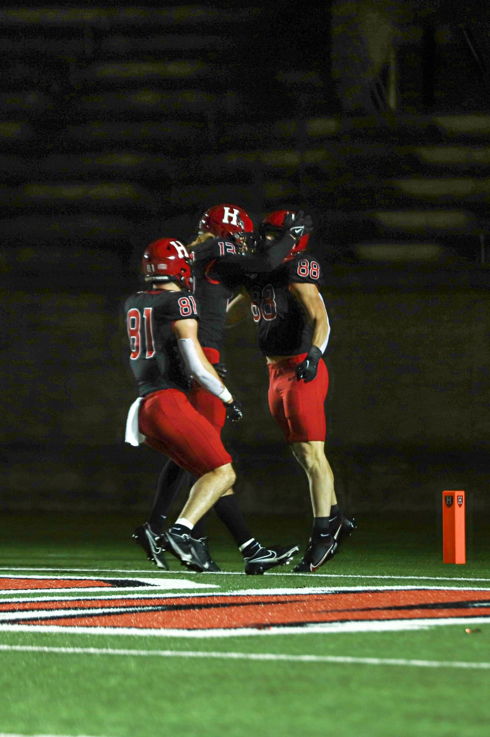 Junior tight end Tyler Neville (88) celebrates with sophomore wide receiver Ledger Hatch (13) and senior tight end Haven Montefalco (81) after his second-quarter touchdown. Neville, who hauled in five passes for 78 yards and a touchdown, was one of the few bright spots for Harvard on Friday.
