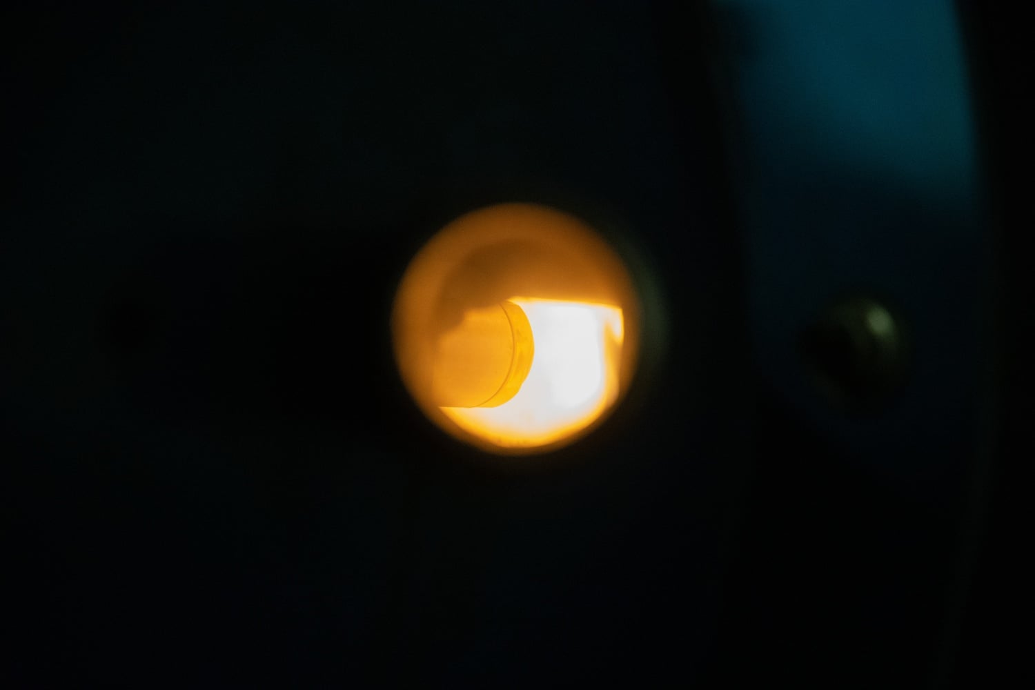 Through the glass end of a thin metal tube, we can see the single fire that ultimately provides heat to the Quad.