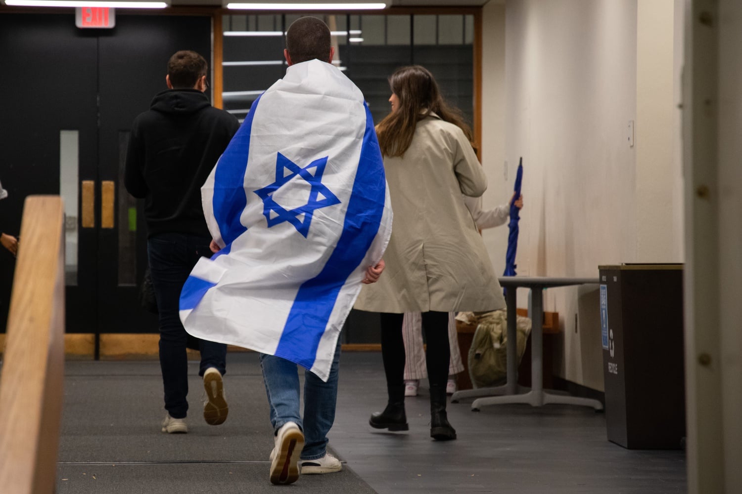 Pro-Israel students protesting the event held signs and carried Israeli flags.