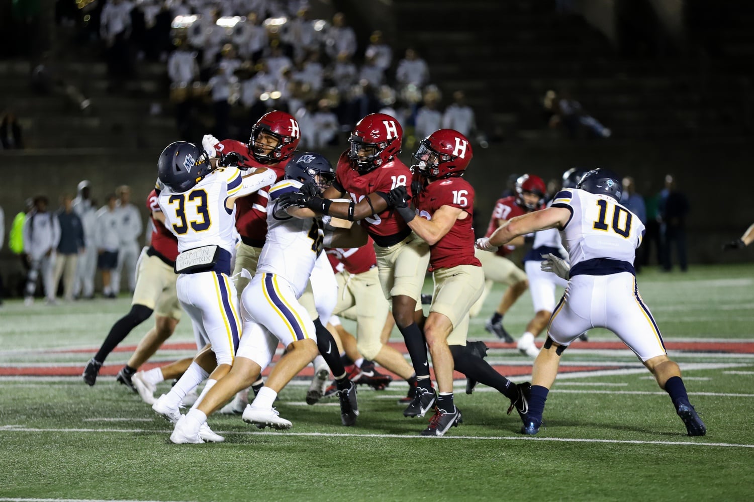 Senior defensive back James Herring fights for a punt block in a 28-21 overtime win over Merrimack on Sept. 16. Although he failed to come up with the block on this play, Herring and the Crimson are second in the nation with seven blocked kicks this season.