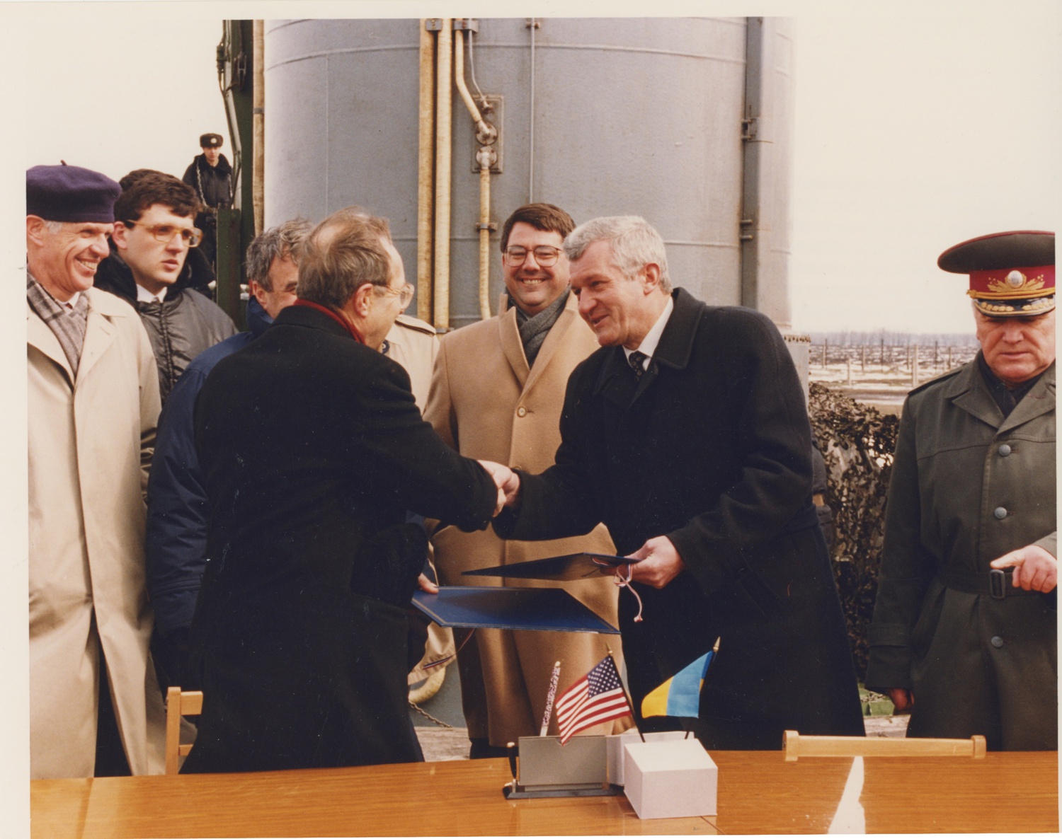 Ash Carter, center, looks on as U.S. Defense Secretary William Perry and Ukrainian Defense Minister Valeriy Shmarov shake hands after signing an agreement providing the Ukraine with assistance dismantling its nuclear weapons arsenal in 1995.