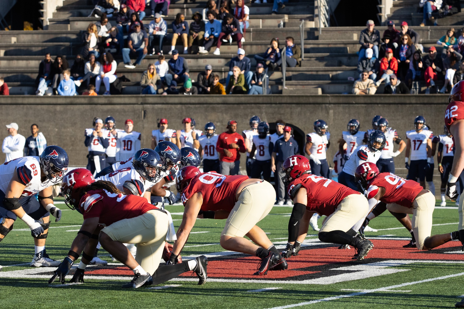 Harvard's defensive line prepares for a snap in a 23-7 victory over Penn on Nov. 13, 2021. Led by junior defensive tackle Thor Griffith (50), the Crimson was elite again on Saturday, holding the Quakers to nine yards on 15 carries.