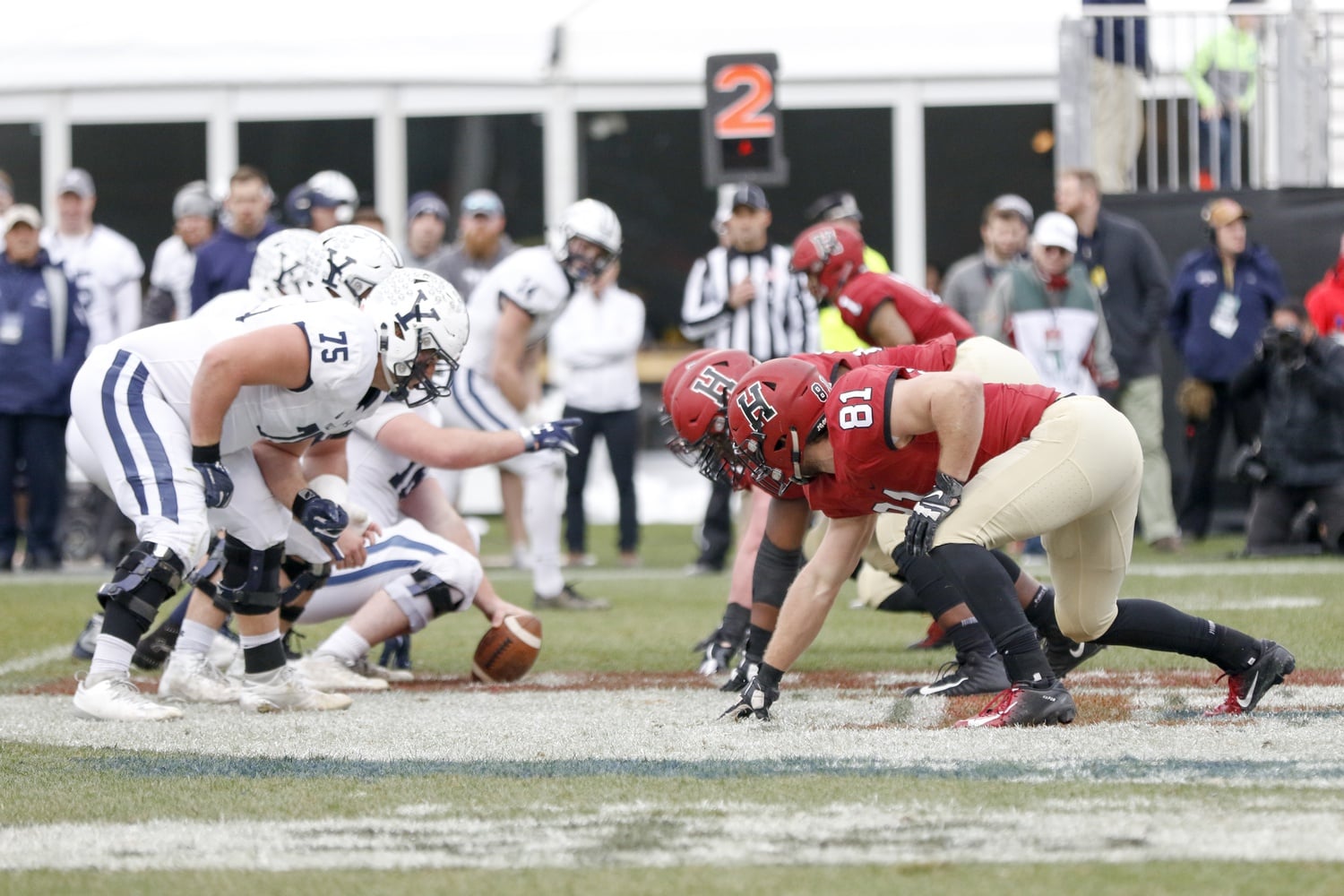 The Harvard defensive line prepares for a snap in a 45-27 win over Yale at Fenway Park on Nov. 17, 2018.