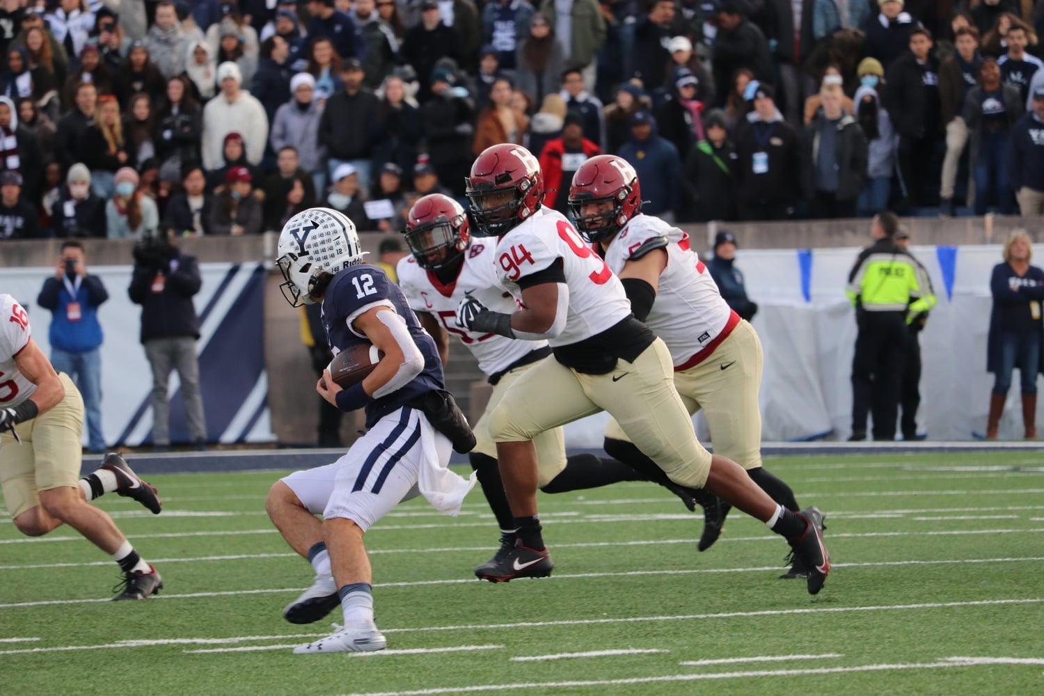 Then-junior defensive linebacker Anthony Nelson chases down Yale signal-caller Nolan Grooms on a 3rd and 7 play late in Harvard's 34-31 victory over the Bulldogs. The coverage sack resulted in a 4th and 8, which allowed the Crimson to take back possession for its game winning drive.