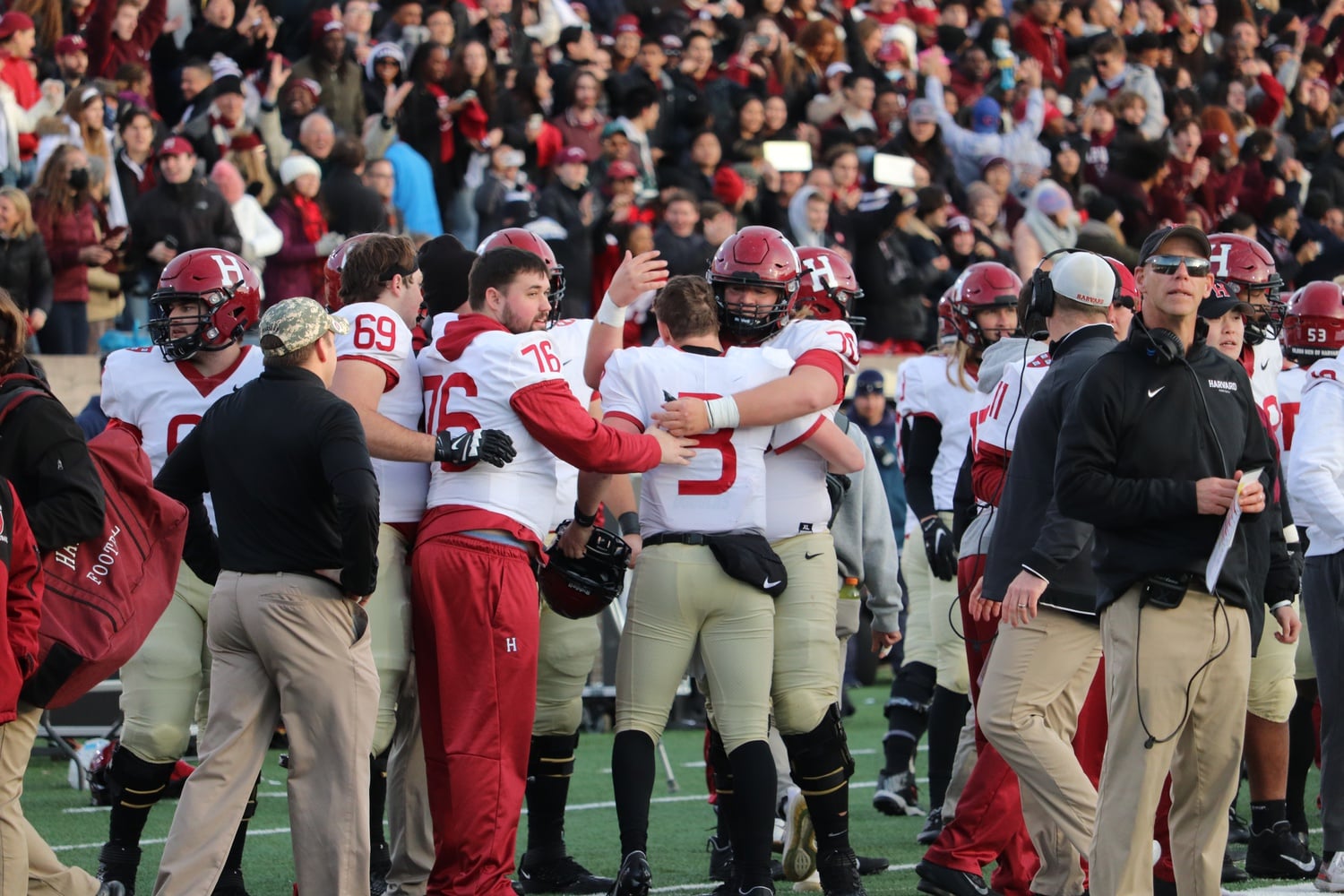 Then-junior quarterback Luke Emge embraces then-sophomore offensive lineman Scott Elliott after Harvard's 34-31 win on Nov. 20, 2021. The win was the capstone to a successful season, and the emotion was evident for the Crimson after the game.