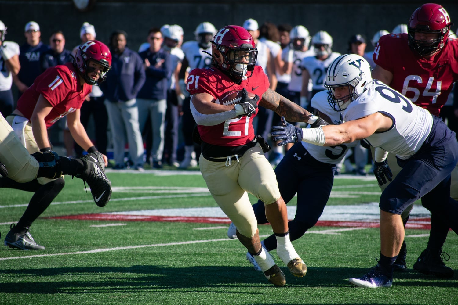 Senior running back Aidan Borguet looks to make a cut after receiving a first-half handoff from senior quarterback Charlie Dean. It was a tough finish to his brilliant Harvard career, as he was held to 62 yards on his 18 carries.