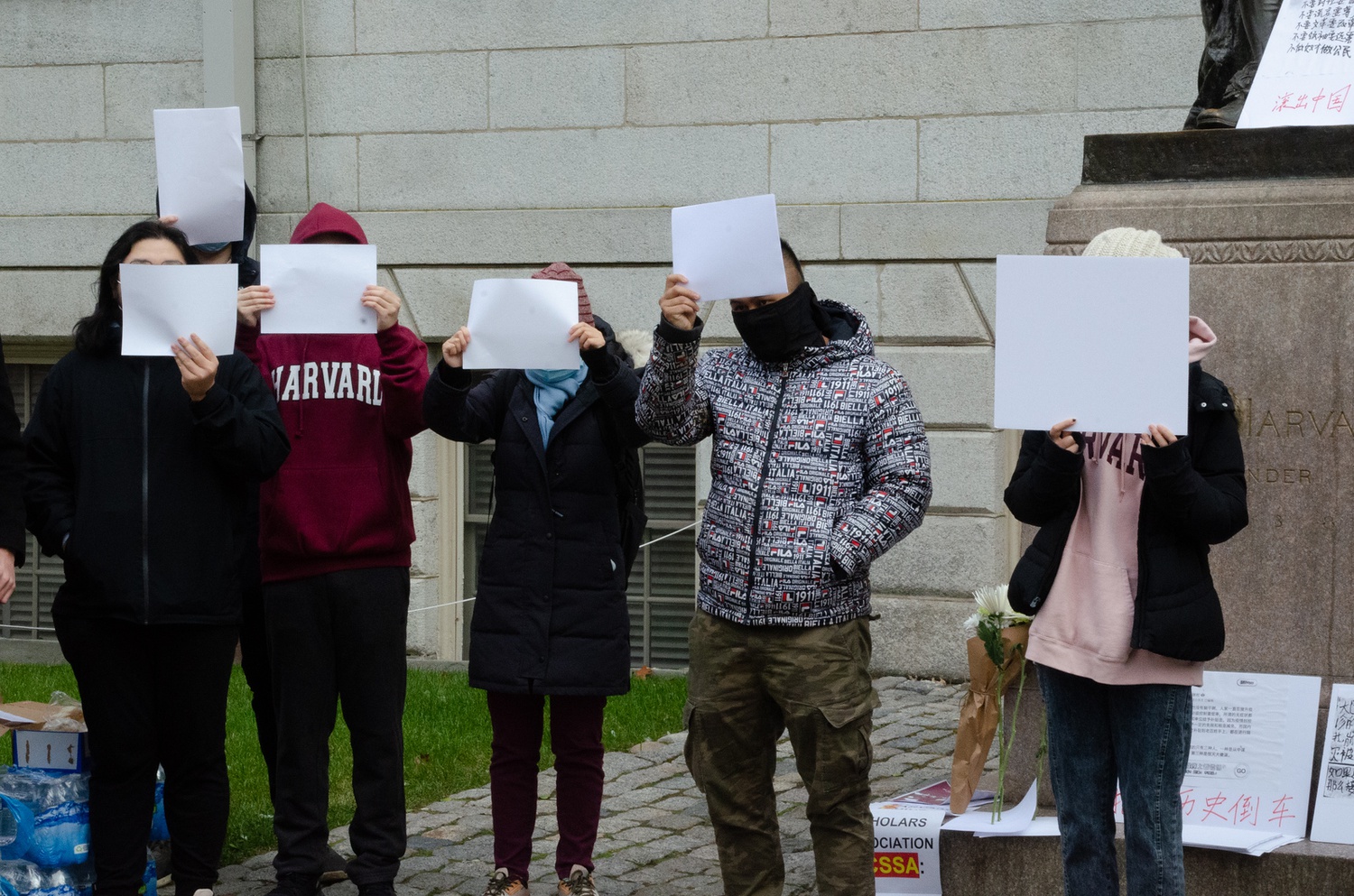 Demonstrators on campus covered their faces with white sheets of paper during a protest against the Chinese government's handling of Covid-19.