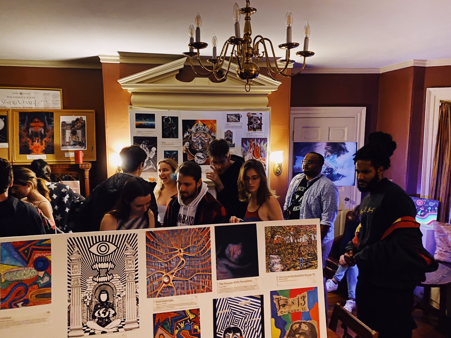 Visitors at the Signet Society browsing student art.