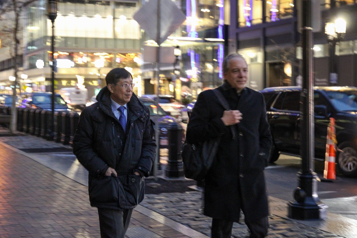 Jie “Jack” Zhao, left, leaves the John Joseph Moakley United States Courthouse with his attorney, William D. Weinreb, after the eighth day of the trial.