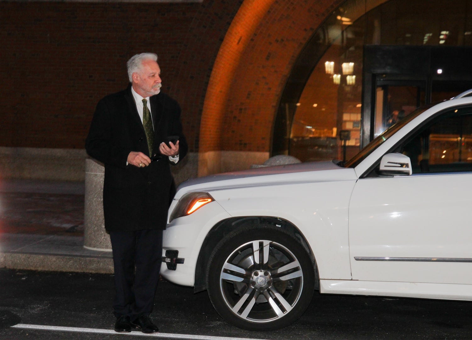 Former Harvard fencing coach Peter Brand, accused of accepting bribes from a wealthy businessman, exits John Joseph Moakley U.S. Courthouse.