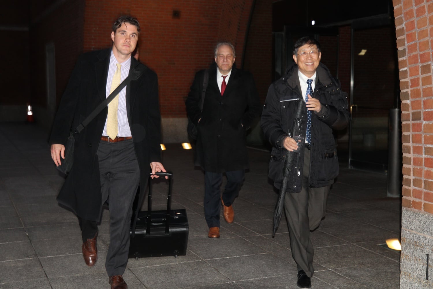 Jie "Jack" Zhao, right, exits John Joseph Moakley U.S. Courthouse on Monday following testimony from his sons.