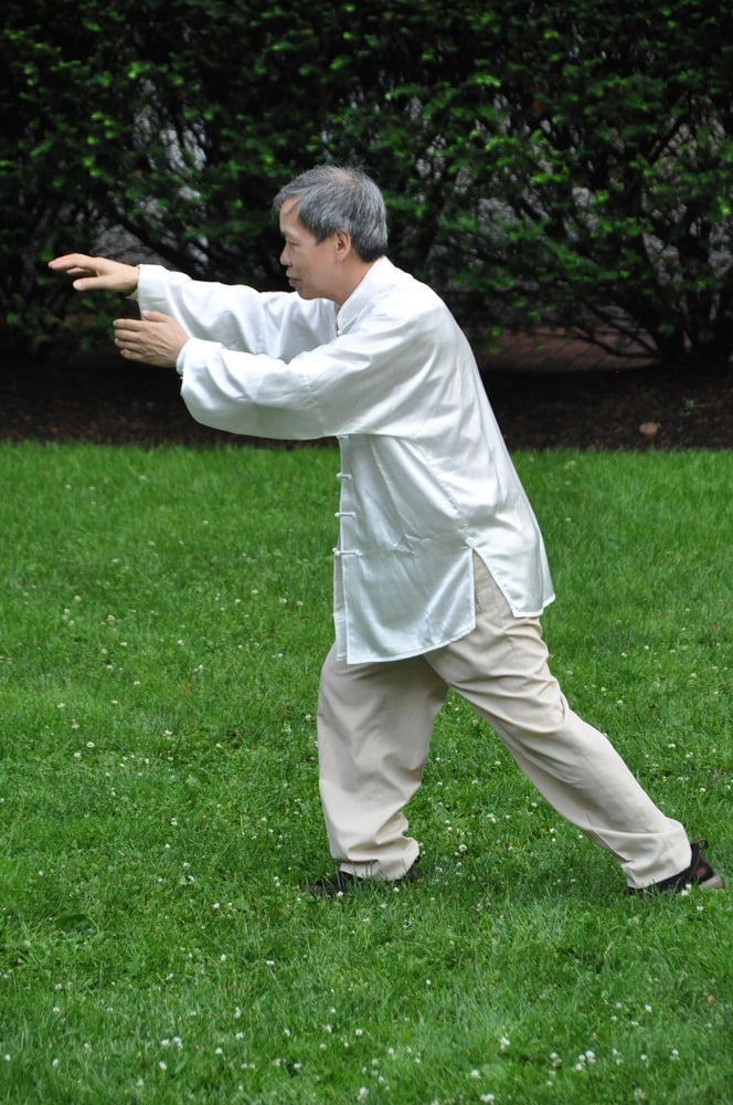 Lee, Harvard's chief instructor of kung fu and tai chi, demonstrates his form in Adams House's Randolph Courtyard.
