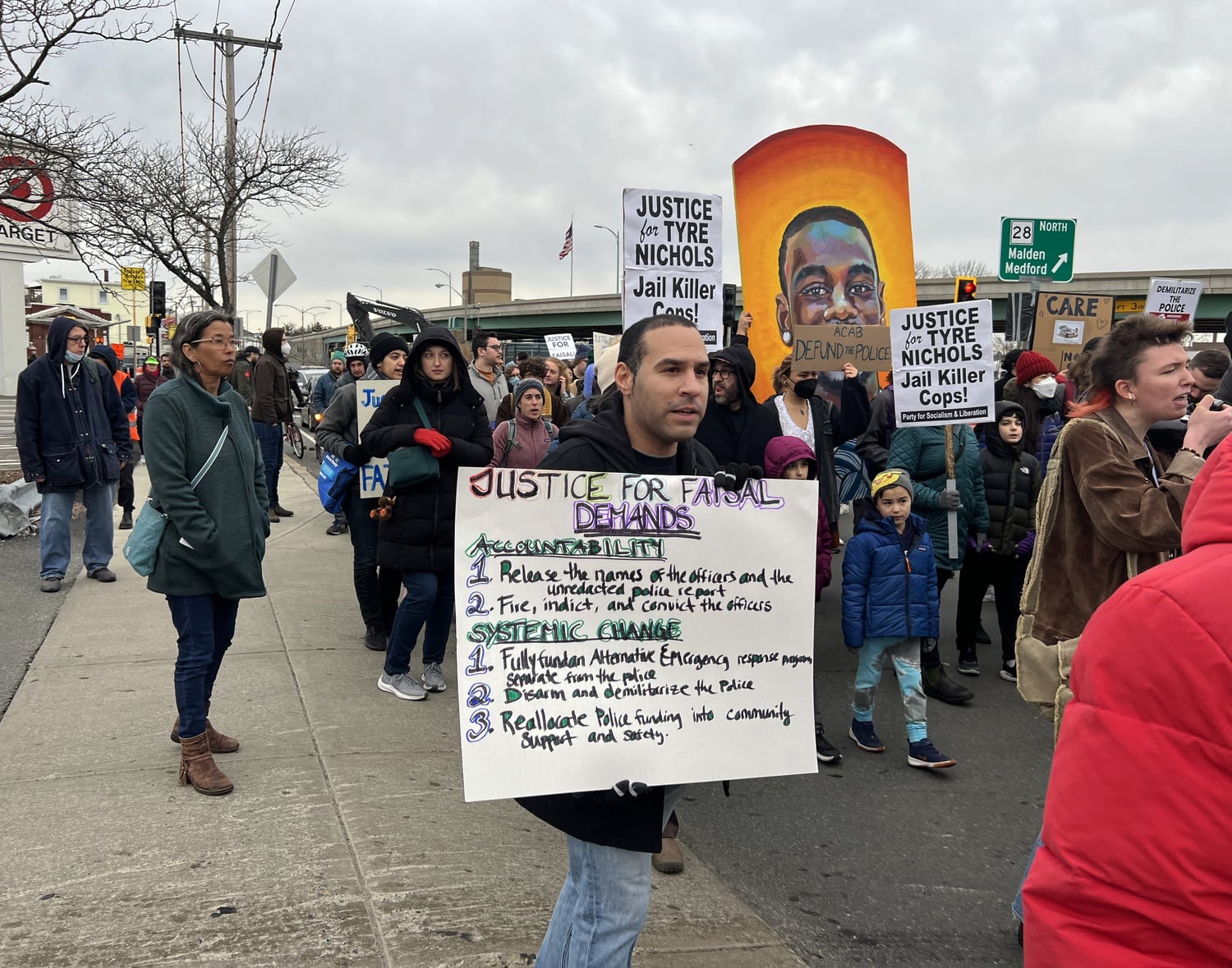 Walking towards the Cambridge Police Station, protesters hold up signs calling for justice after the deaths of Sayed Faisal and Tyre Nichols. Both were killed in January by police, sparking protests for reform.