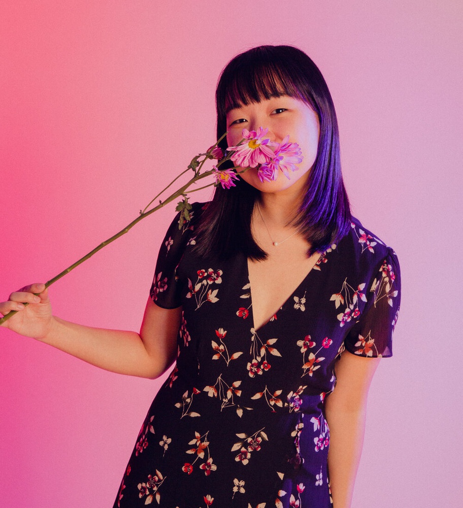 Karen Chee photographed with a flower.
