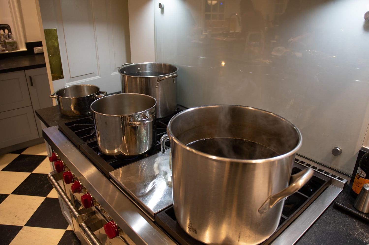 A pot of black tea boils on the stove.