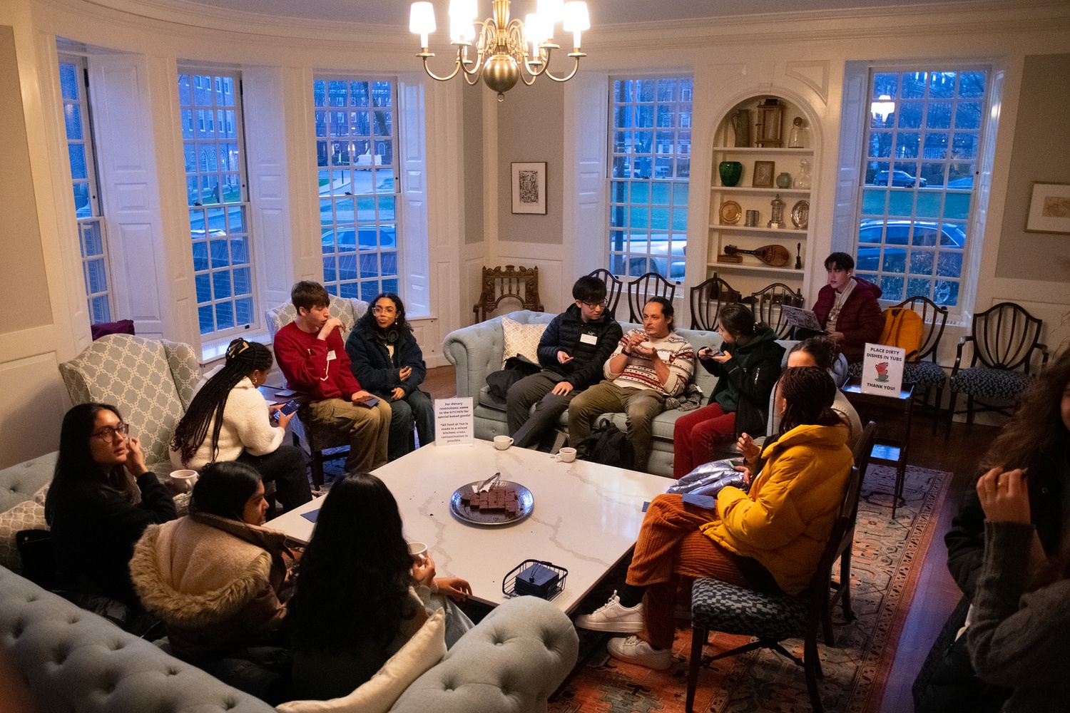 Students enjoy tea and flourless chocolate cake as the crowds come in.