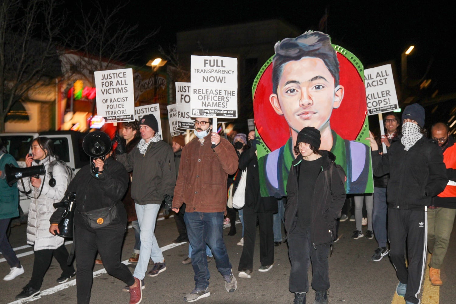 A group of students and activists protesting the police killing of Sayed Faisal marched down Massachusetts Ave. toward Cambridge Police Headquarters.