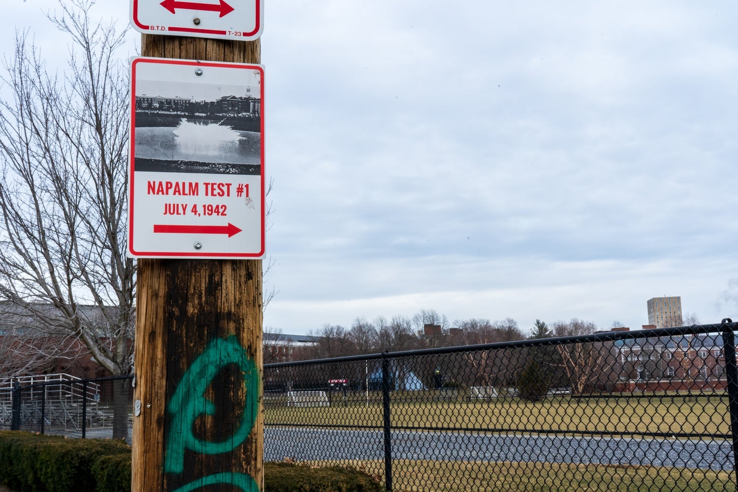 Yang and Miller put up a sign commemorating Napalm's testing at Harvard. On the sign is an image of napalm exploding on Ohiri Field. A QR code sticker on the back of the sign links to more information about napalm’s origins.