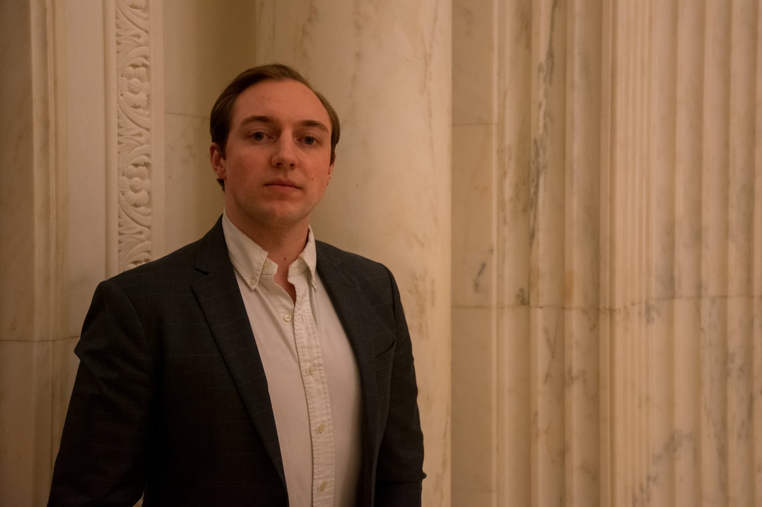 Quinn H.J. Ewanchyna ’25, a veteran who attends Harvard College, stands in Widener Library.
