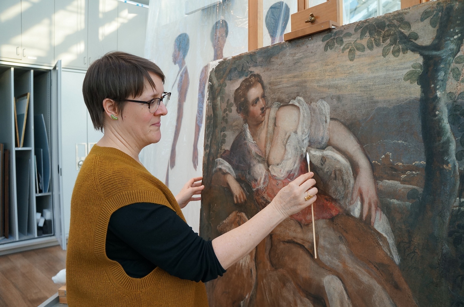 Her intimate proximity to paintings differs from the plebeian museum goer’s protocol.