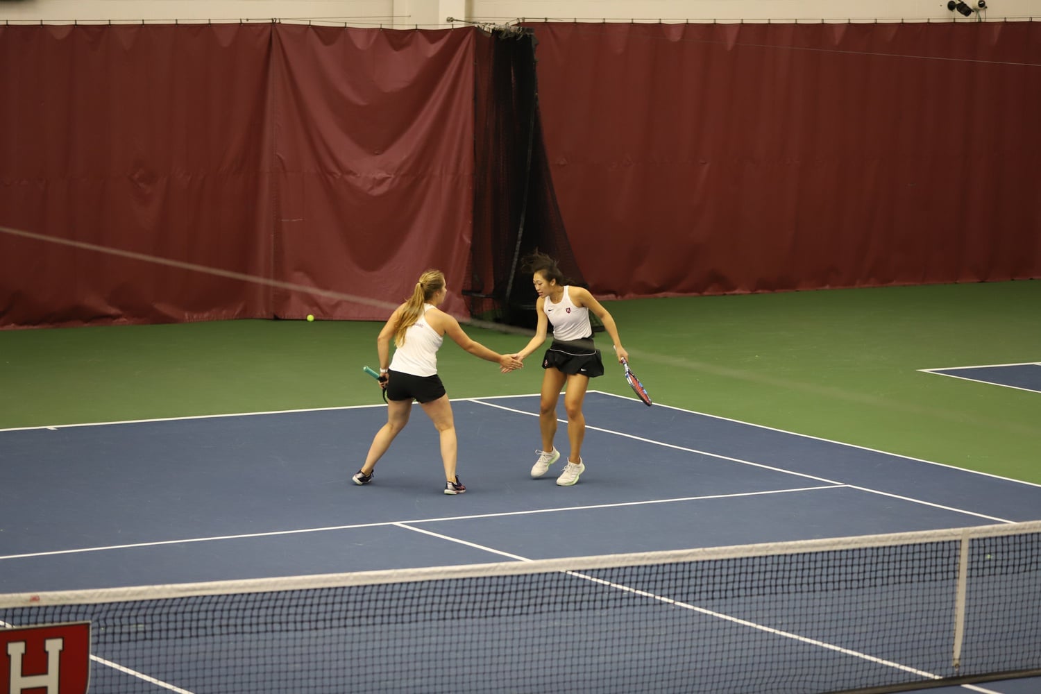 The Crimson celebrate winning a point against Boston College on November 7, 2021