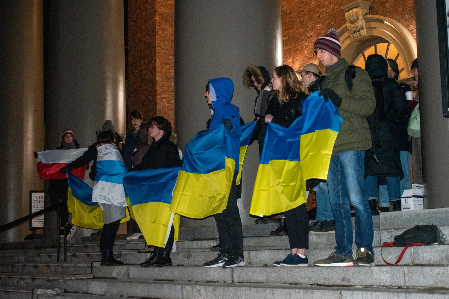 Students stand on the steps of Memorial Church, holding Ukrainian flags in solidarity. The concert marked the one-year anniversary of Russia's invasion into Ukraine.