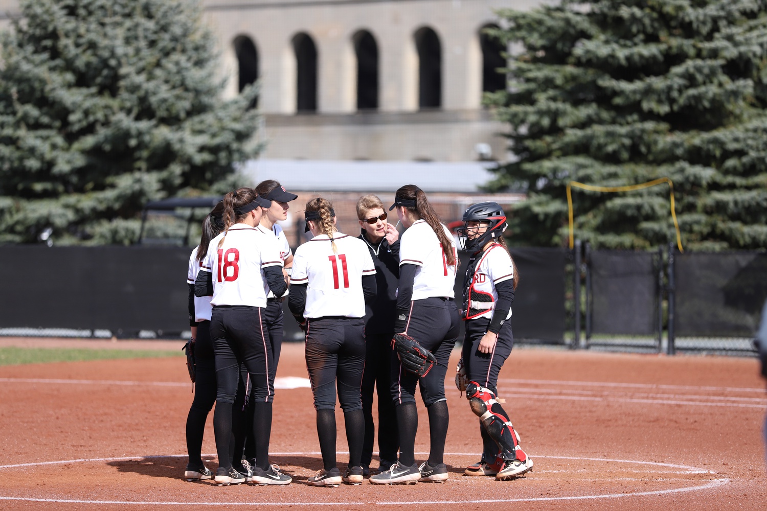 Head coach Jenny Allard gathers her players on the pitchers mound against BU on April 5, 2022.