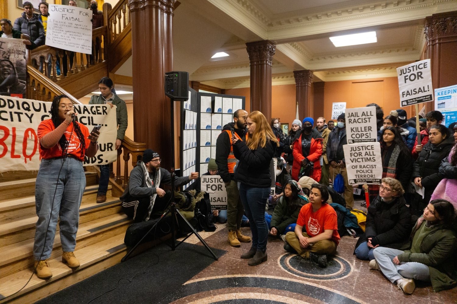 More than 100 people took on Cambridge City Hall the latest demonstration in a nearly two-month campaign to demand accountability for the police killing of Sayed Faisal.