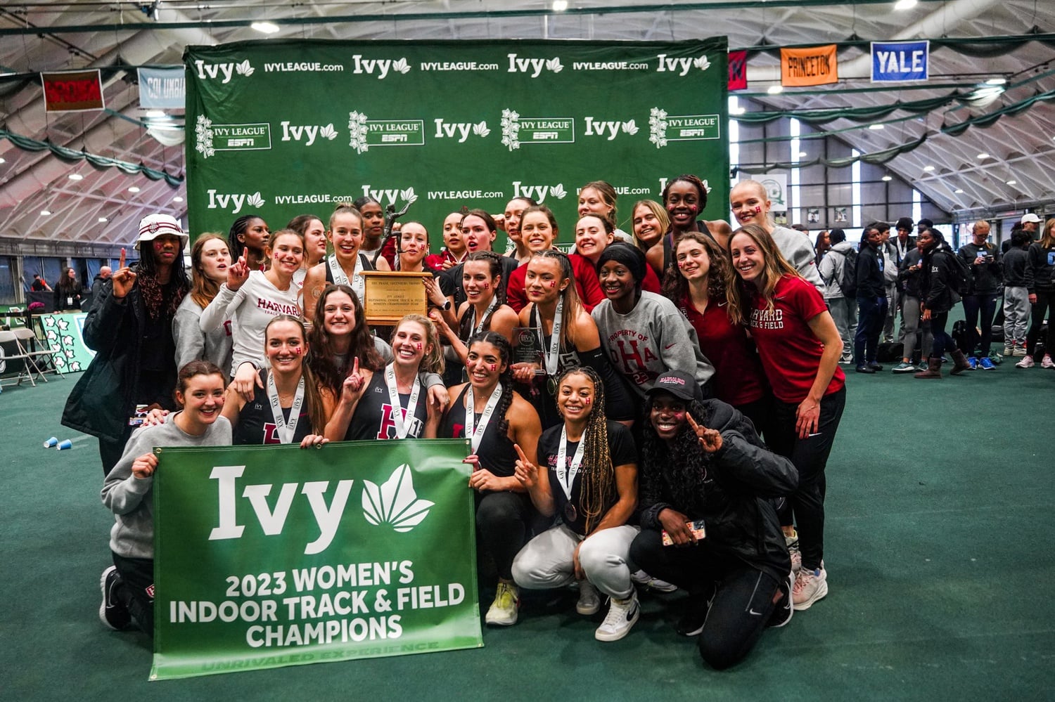 The Harvard women's track team celebrates its 2023 Ivy League Championship title in Hanover, N.H. Last year, the Crimson also took first place.
