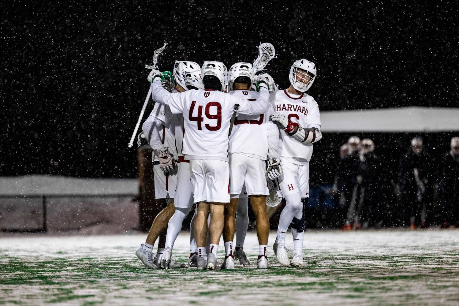 The Harvard men's lacrosse team huddles up against Bucknell on February 25.