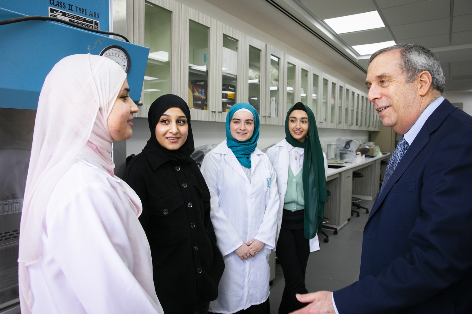 University President Lawrence S. Bacow, right, speaks to undergraduates at the Abu Dis campus of Al-Quds University in Palestine.