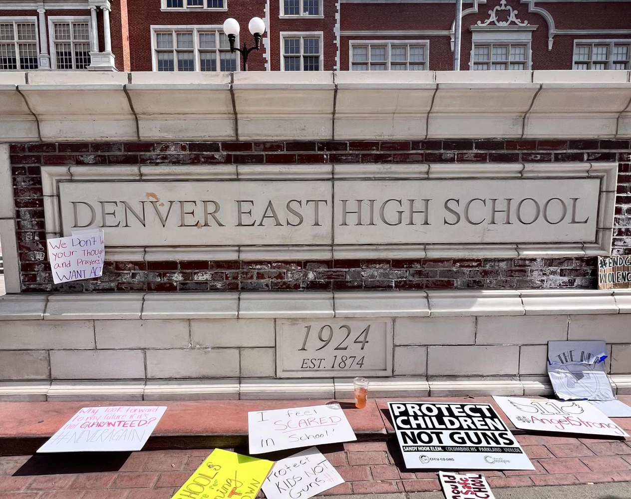 Signs from a recent student protest lay near the entrance of Denver’s East High School.