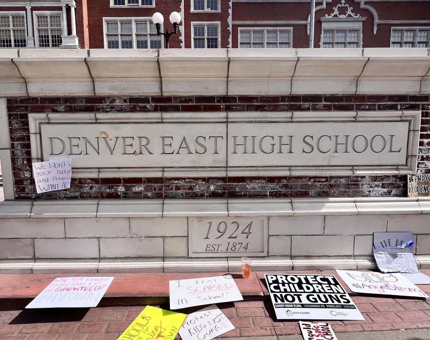 Signs from a recent student protest lay near the entrance of Denver’s East High School.
