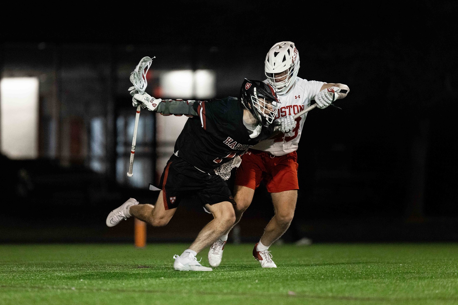 Sophomore attacker Sam King tussles with a Boston University player in Harvard's battle against the Terriers on March 21, when the Crimson lost 15-11. King leads the team in the number of goals scored at 20.