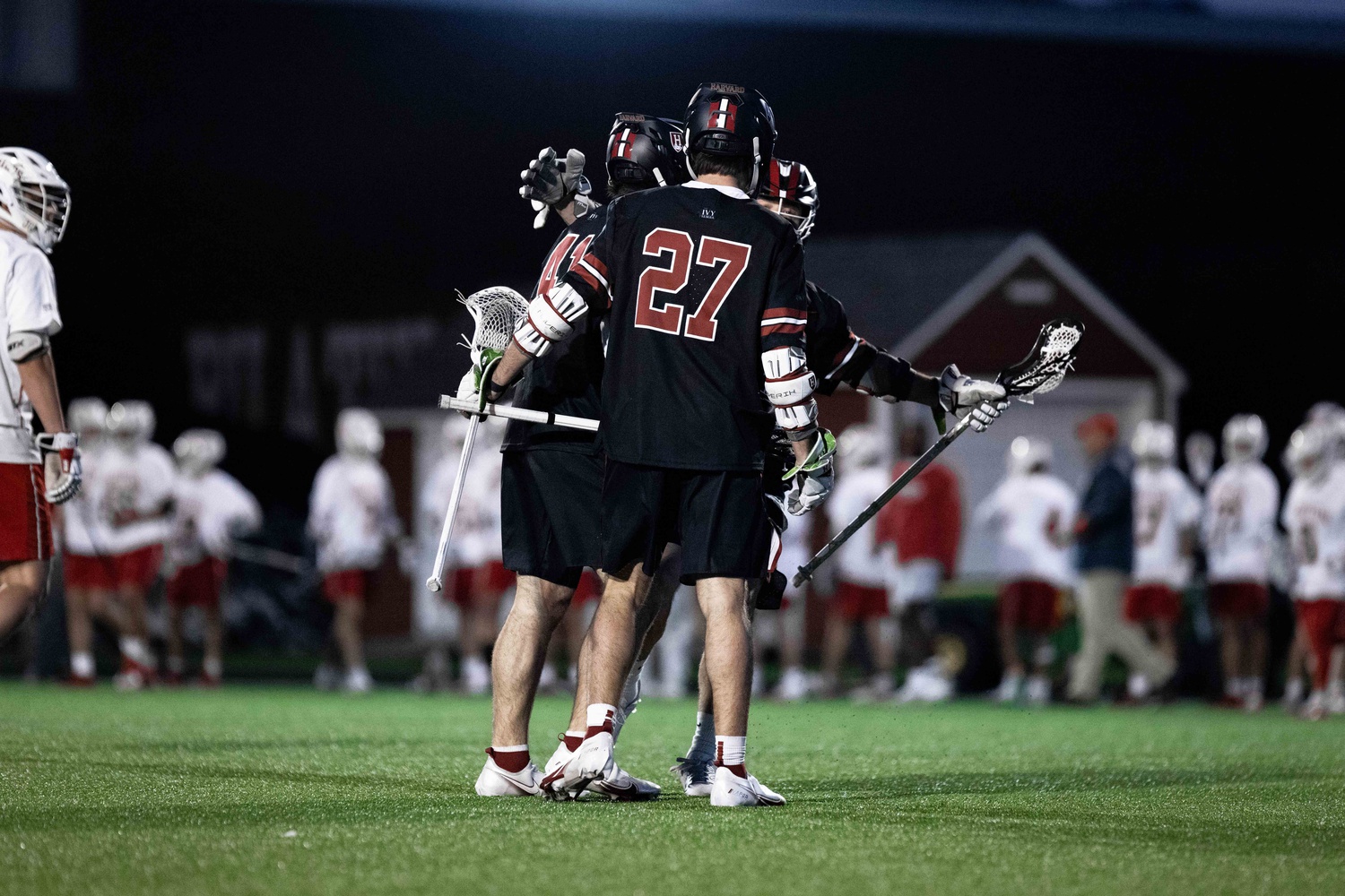 Members of the Harvard men's lacrosse squad huddle at its game against Boston University in Boston, Mass. The Crimson will next travel to Hamilton, N.Y. to play Colgate University on Saturday at 1:00 p.m. EST.
