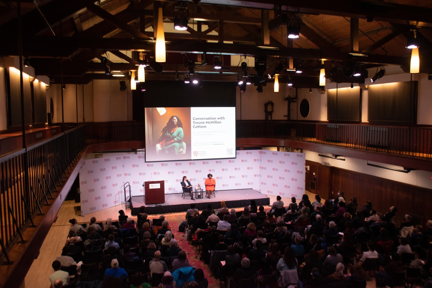 Tressie McMillan Cottom, a sociologist and 2020 MacArthur Fellow, and Tomiko Brown-Nagin, Dean of the Radcliffe Institute, speak to a crowd at the Knafel Center.