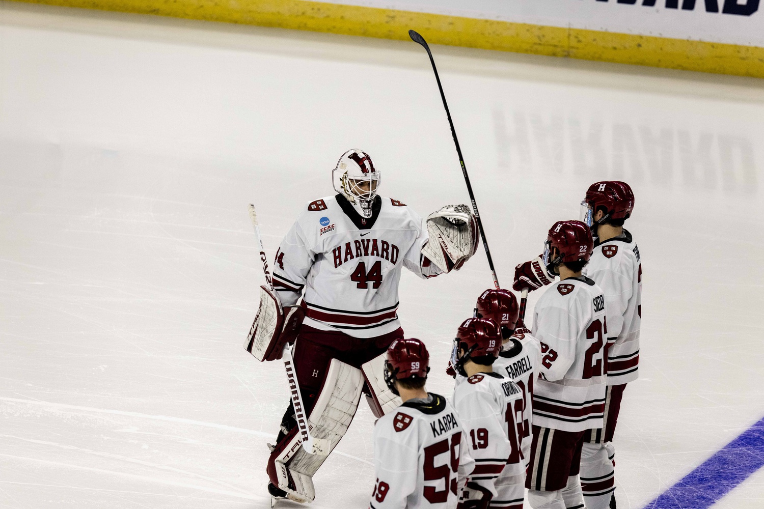 Former Harvard goalie Mitchell Gibson greets his teammates as the starting lineup is announced against Ohio State on March 24th.