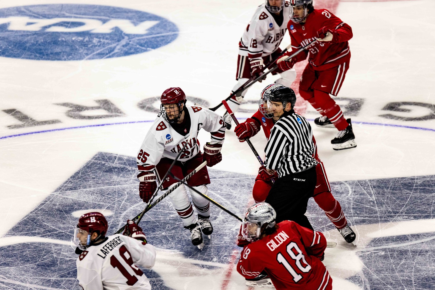 Former Crimson forwards John Farinacci and Alex Laferriere look for the puck against Ohio State on March 24th.