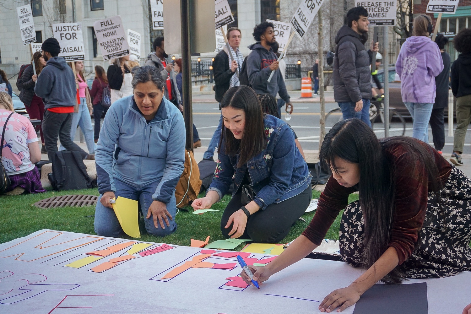 Protesters made signs for their picket outside Cambridge City Hall.