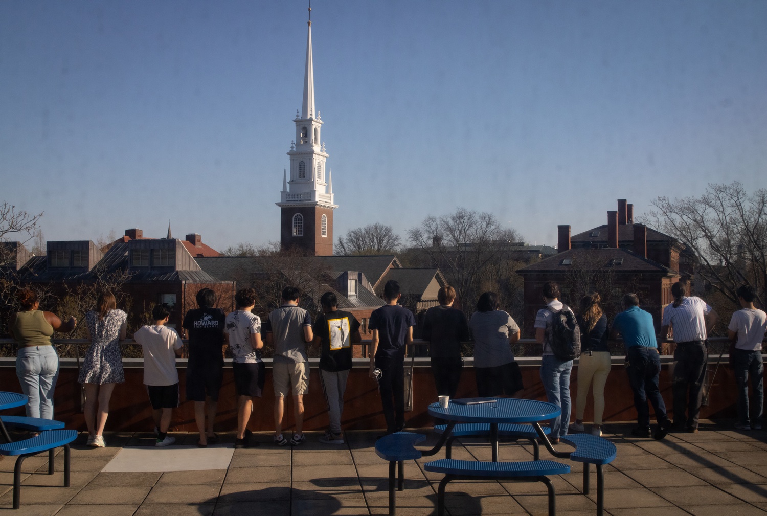 A crowd of students view police activity in Science Center Plaza from the Science Center's fourth floor balcony.