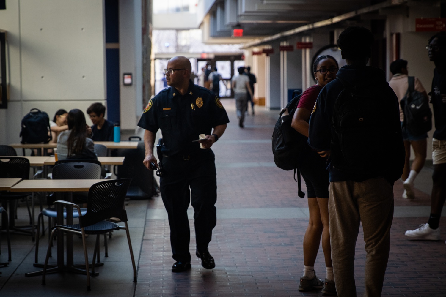 A Harvard University Police Department officer walks through the Science Center.