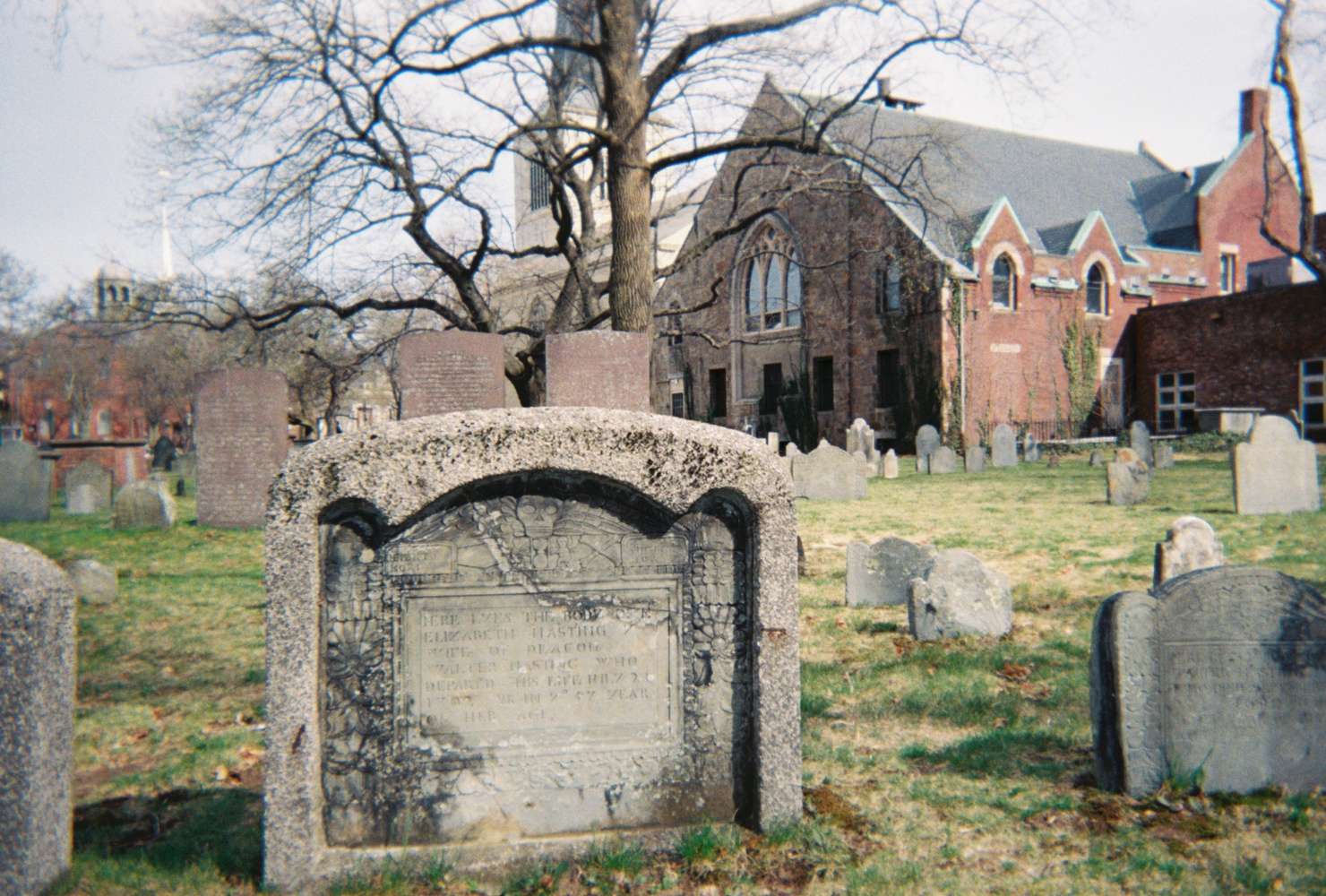 The tombstones are remnants of Puritan-era craftsmanship that the Fannins take pride in preserving. Many of them are painstakingly carved with images of the “death’s head” — a foreboding, winged skull, etched alongside phrases like “memento mori” (remember you must die) and “fugit hora” (the hour flies).
