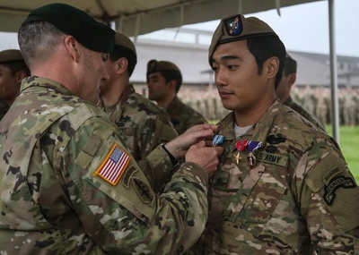 Cover image for Nicholas C. Ige ’25 being awarded the Bronze Star, Purple Heart, and Military Valor medals.