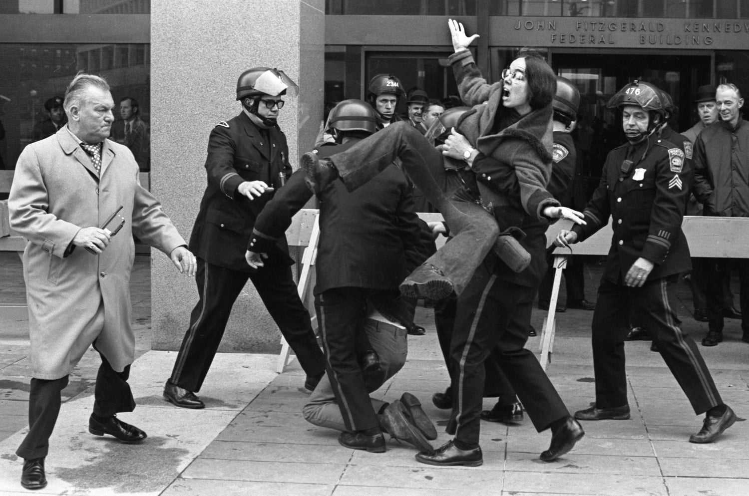 Police restrain an anti-Vietnam War protester outside the John F. Kennedy Federal Building in May 1972.