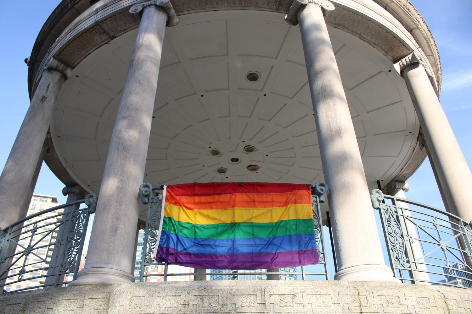 A Pride flag flies at the front of the Parkman Bandstand in the Boston Common for a 2022 Pride celebration.
