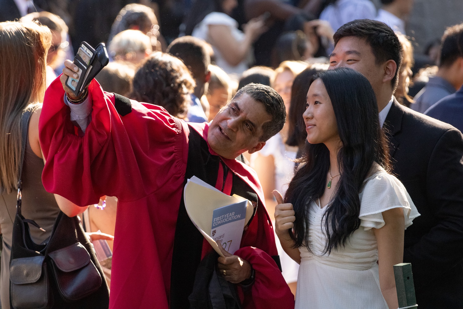 Harvard College Dean Rakesh Khurana snaps a selfie with students at the Class of 2027 Convocation Monday.