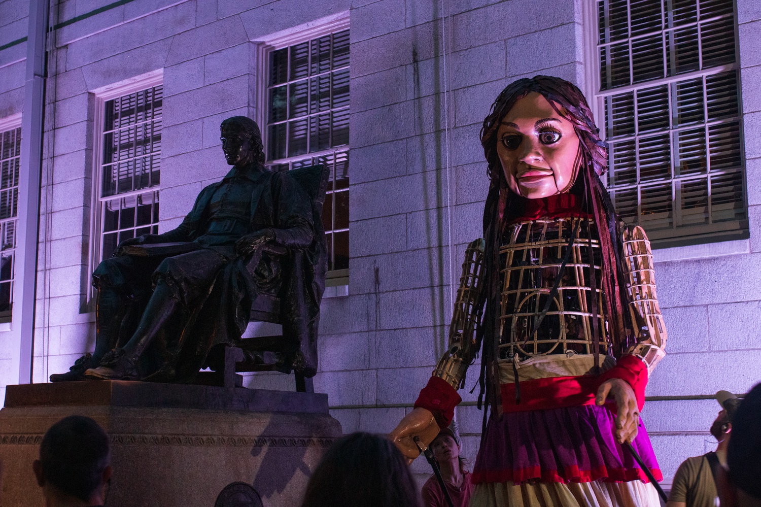 Hundreds of Harvard affiliates and local residents welcomed Little Amal, a 12-foot-tall puppet of a young Syrian refugee, to Harvard's campus Thursday.