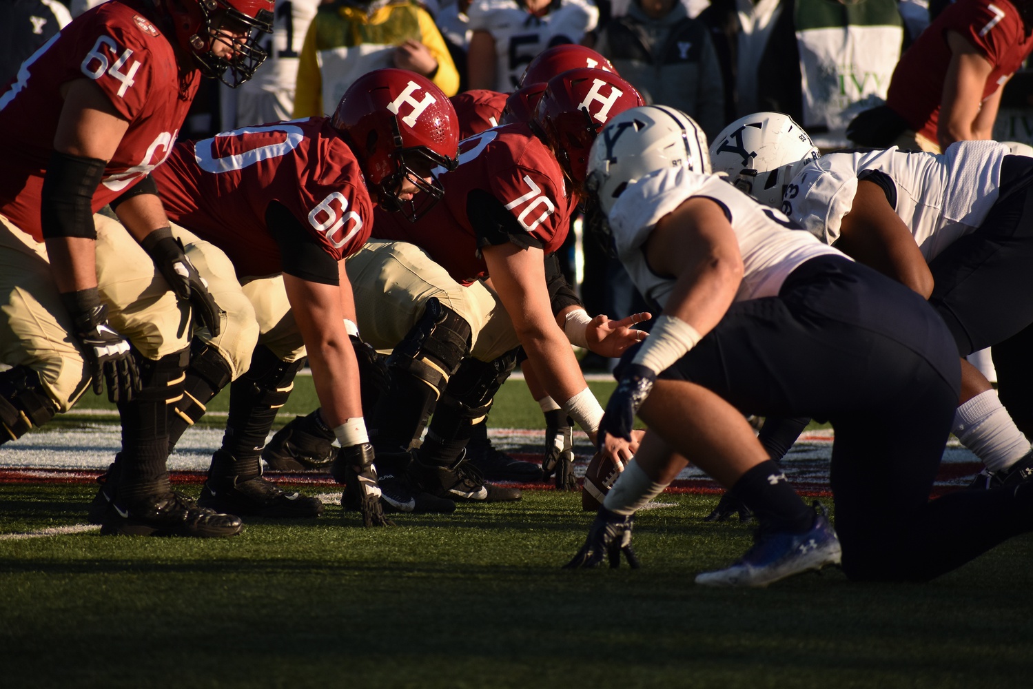 Harvard football offense lines up for a play in the 138th rendition of "The Game" at Harvard Stadium on Nov. 19, 2022. This year, the Crimson will face the Bulldogs for the annual Harvard-Yale game in New Haven, Conn. on Nov. 18, 2023.